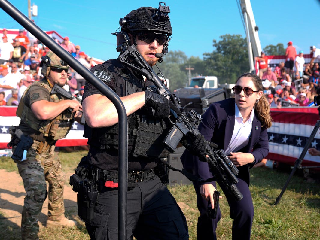 U.S. Secret Service agents converge to cover Republican presidential candidate former President Donald Trump at a campaign rally, Saturday, July 13, 2024, in Butler, Pa. 