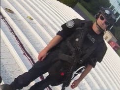 A police officer stands on a rooftop near the body of Thomas Matthew Crooks, the man who attempted to assassinate former President Donald Trump. 