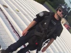 A law enforcement officer stands on the rooftop moments after Thomas Matthew Crooks attempted to assassinate former President Donald Trump. 