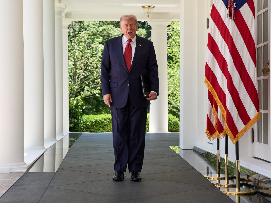 President Donald Trump walks through the Colonnade of the White House as he arrives to attend a luncheon for mothers Friday, May 8, 2026, in the Rose Garden of the White House, in Washington.