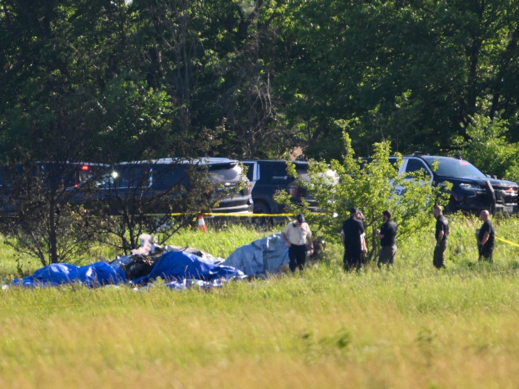The wreckage of a plane crash burns in a field in Butler, Mo, Sunday, June 14, 2026.
