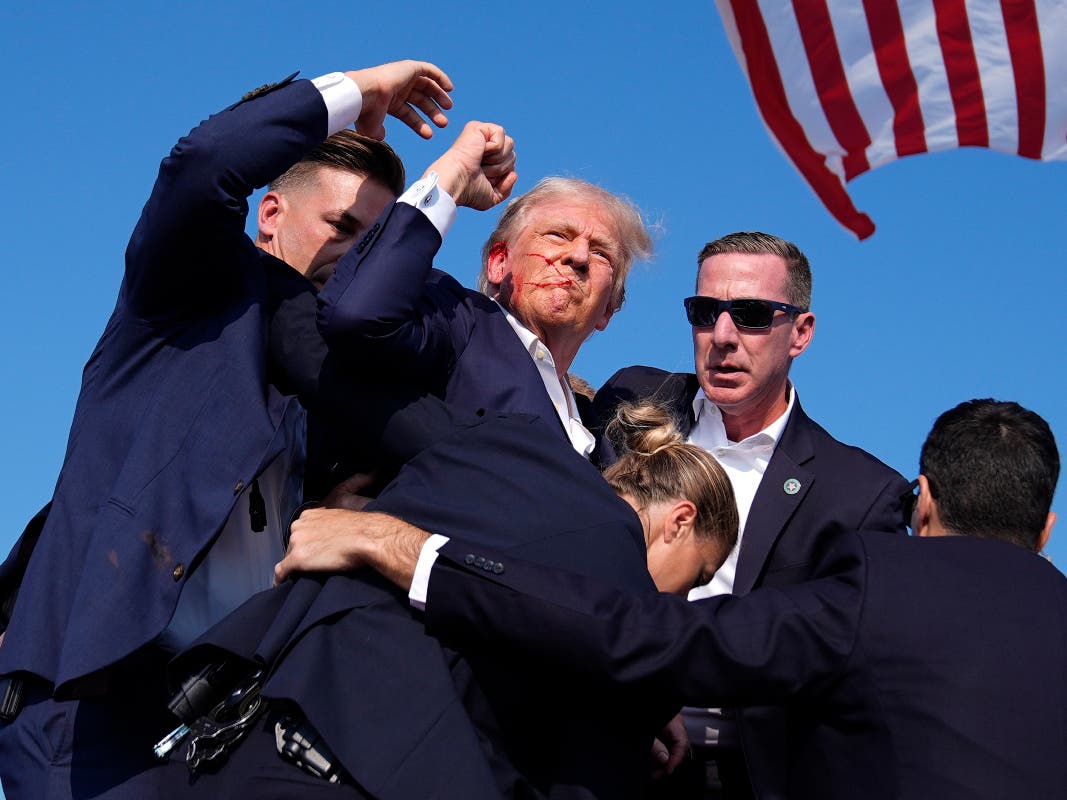 ILE - Republican presidential candidate former President Donald Trump is surrounded by U.S. Secret Service agents at a campaign rally, July 13, 2024, in Butler, PA.