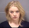 Nicole Horton, 24, was charged with aggravated unlawful use of weapon, four counts of unlawful possession of a firearm/ammunition, four counts of no FOID card, and possession of a stolen firearm.