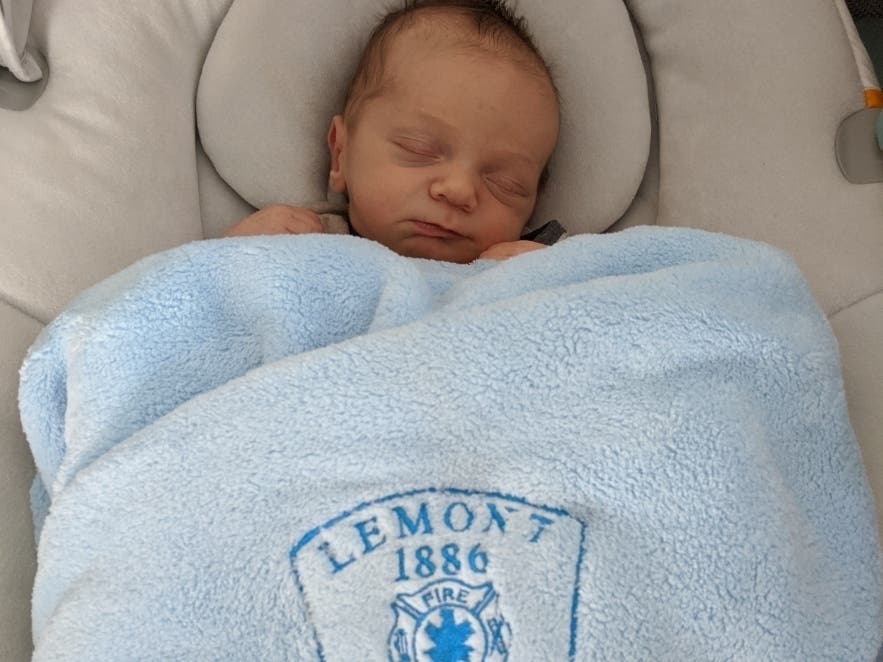 The paramedics who delivered Theodore visited the family recently and gave them a blue baby blanket with the fire department logo on it.