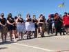 Several organizers and protesters spoke during the event, while some protesters held signs along 127th Street.