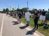 Several organizers and protesters spoke during the event, while some protesters held signs along 127th Street.