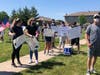 Several organizers and protesters spoke during the event, while some protesters held signs along 127th Street.