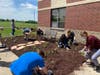 The groups came together on the project, and Landscape Design students designed an area outside door 19 at the school, with a butterfly bench and pathway also included. 
