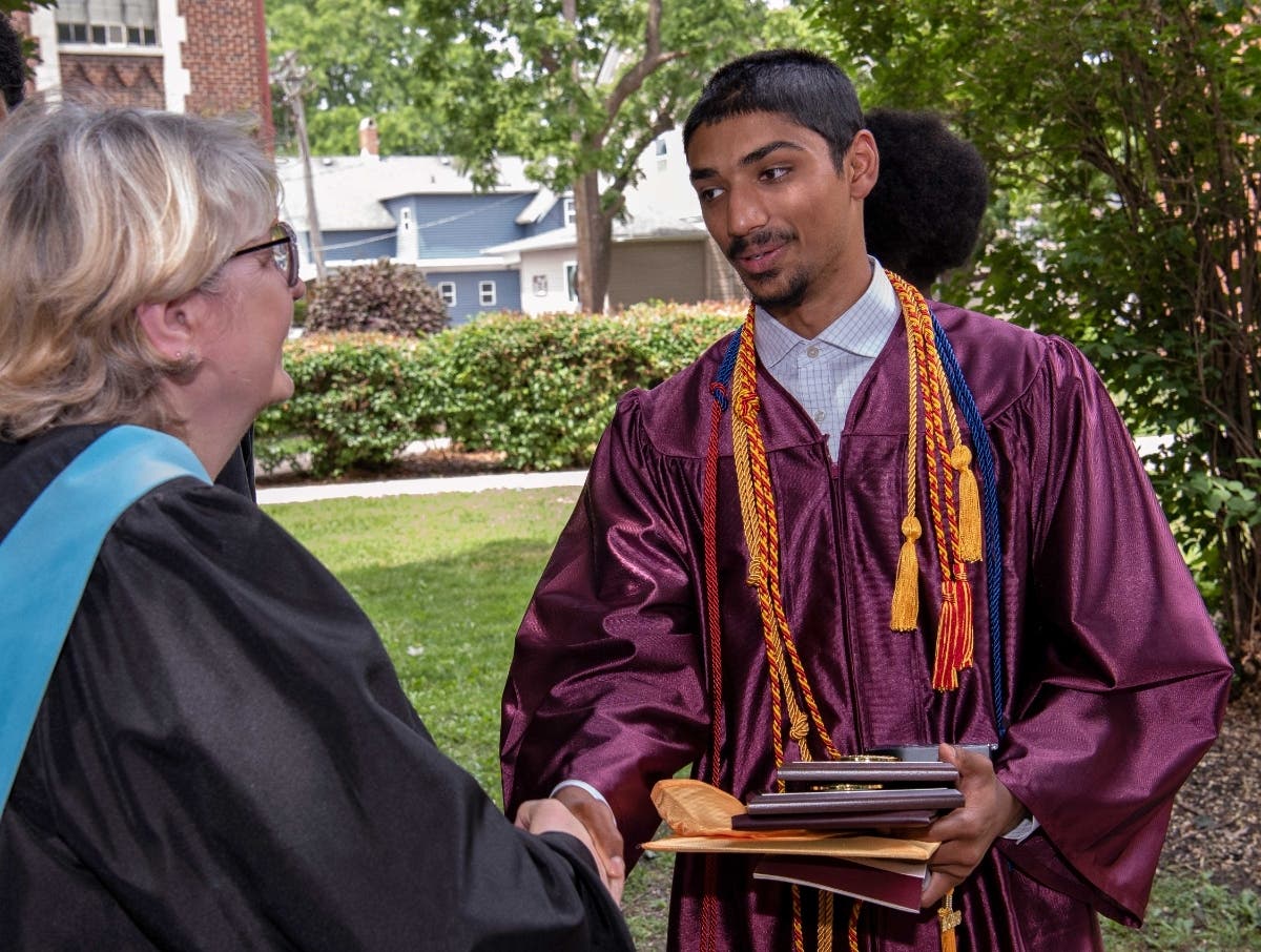 Shaking hands at graduation with Upper School history teacher Paula Etheridge.

