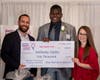 Anthony Djoko of Danvers receiving the Lightshed Photography Scholarship from Dan and Kendra St. John