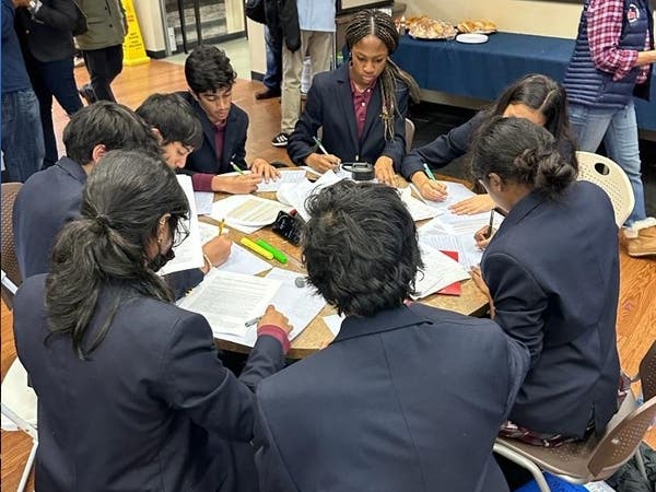 CHP's debate team working diligently with each other to brainstorm arguments. 