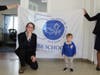 Cobb Montessori's first student, Micheal Cobb Jr with one of Cobb's youngest students pose together during the school 50th flag ceremony.
