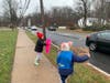Daisy Girl Scouts from Morristown alert drivers to stop and donate food and supplies during the drive-thru food drive.