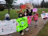 Daisy Girl Scouts held up signs to encourage donors at the drive-thru food drive hosted by Morristown Girl Scouts.