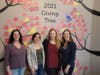 Members of Morristown Area Girl Scouts (from left) Tracy Hassan, Rose Guida, Jerilyn McElwreath, and Valerie Parker pose with the 2021 Giving Tree at the Interfaith Food Pantry in Morris Plains.