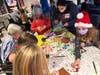 Members of Morristown Area Girl Scouts Brownie Troop 98191 color and decorate holiday banners with residents from Arbor Terrace, an assisted living facility in Morris Plains.