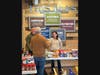 Pastor Leeman talking with volunteers Bob and Jennifer