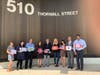 Employees of Mandelbaum Salsburg's Edison office holding signs they made for the Thank You Challenge