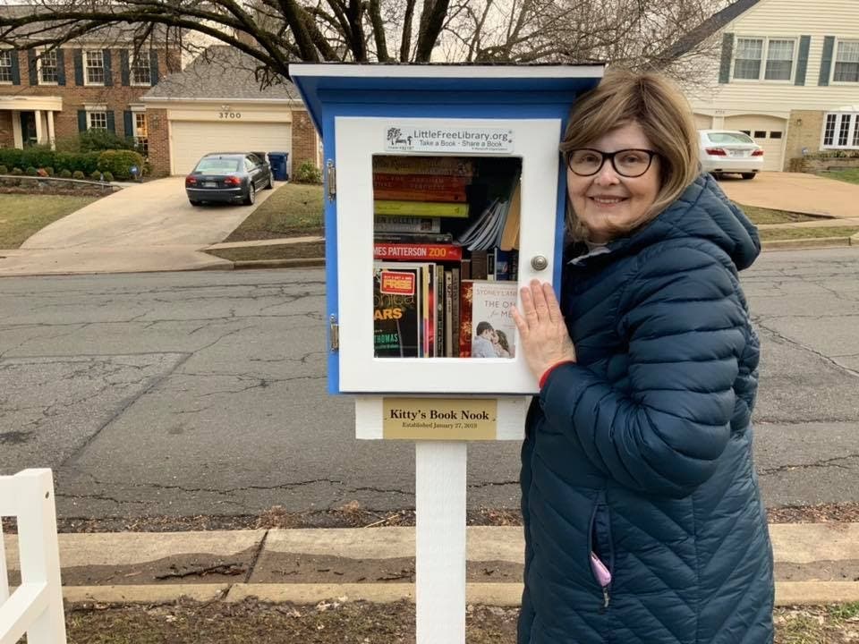 Neighbors flock to the little library outside Kitty Ray's Alexandria home.