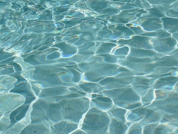 A man was charged with child neglect after he and a baby nearly drowned in a Falls Church pool.