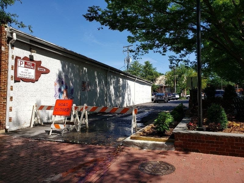 An entrance to a public parking lot has been closed next to the downtown park in Falls Church.