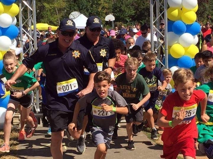 Vienna police officers and kids race at the annual Cops & Kids Fun Run. 