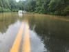 A car is stuck on the flooded Woodburn Road in Annandale on Tuesday, Aug. 4.
