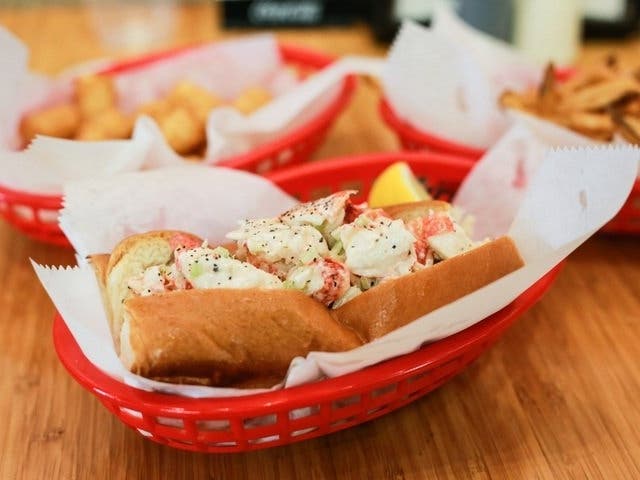 Black-owned business Haute Dogs & Fries is offering a lobster roll dinner for two with kettle chips and a bottle of chardonnay.