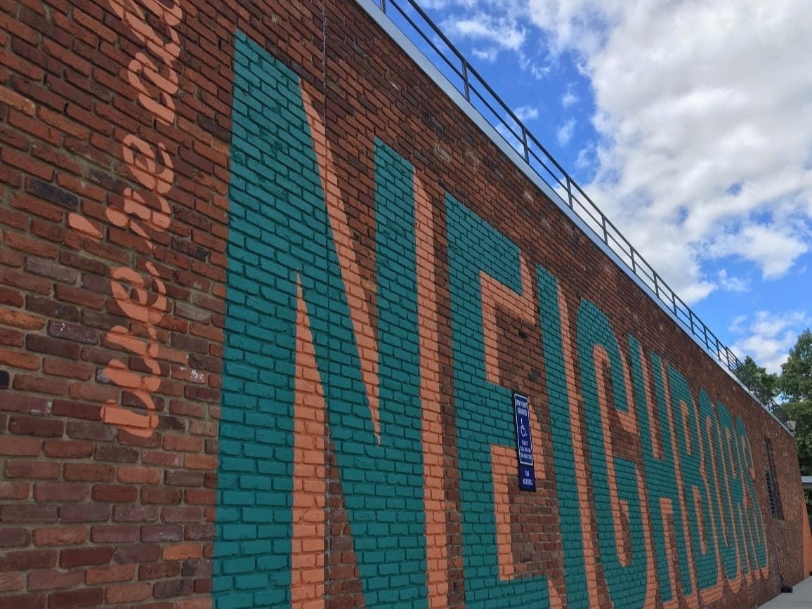 The "Neighbors" mural appears on the side of the Whole Foods store at the Old Keene Mill Shopping Center.