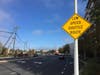 A sign on Eskridge Road notifies drivers of the Relay autonomous shuttle. 