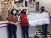 Trisha Stotler and her niece present a check from a fundraiser to Sita (center), the owner of Vienna's Dairy Queen.