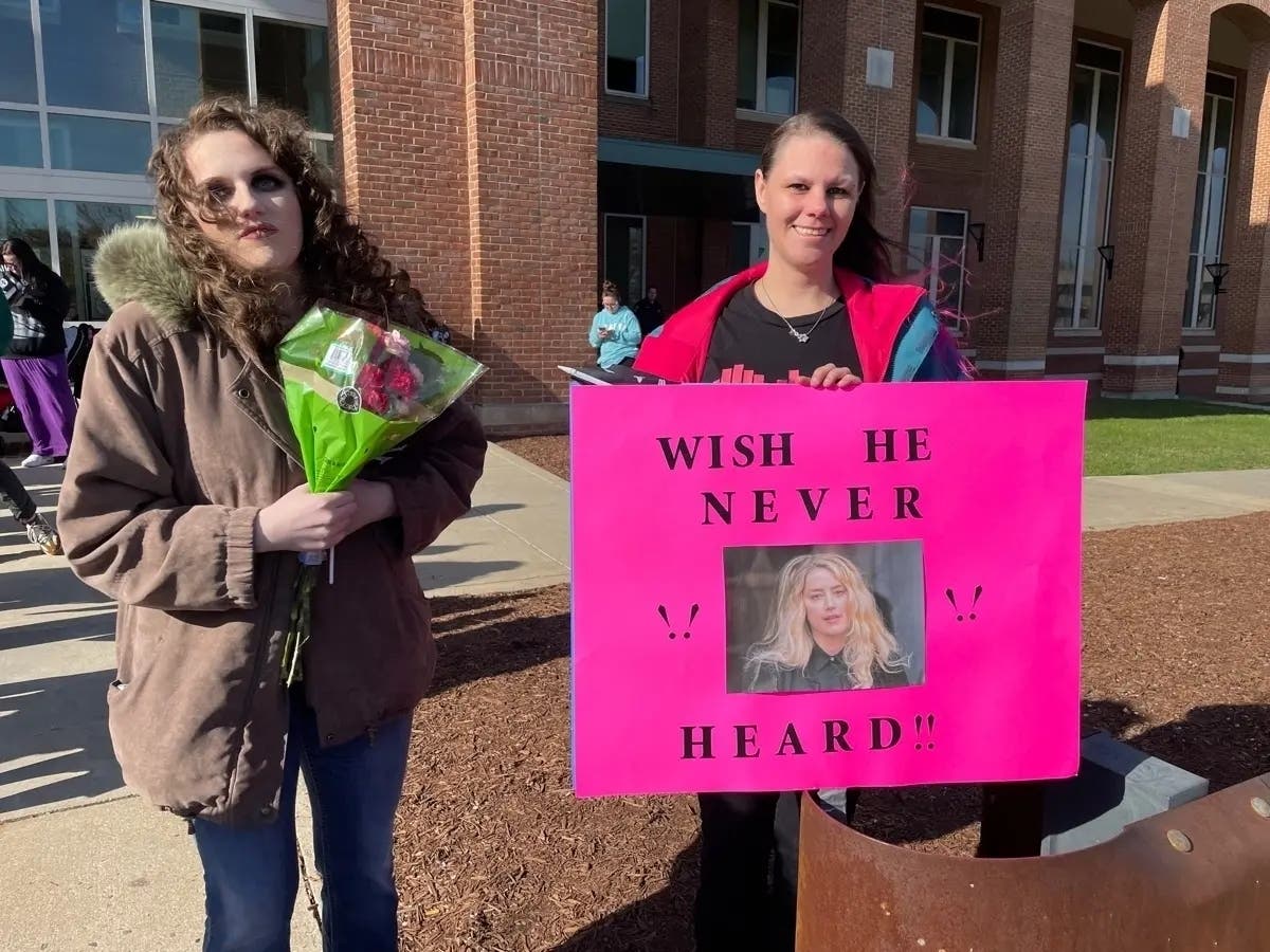Fans stand outside the Fairfax County Courthouse on Monday morning to show their support for actor Johnny Depp on the first day of his defamation trial against ex-wife Amber Heard. 