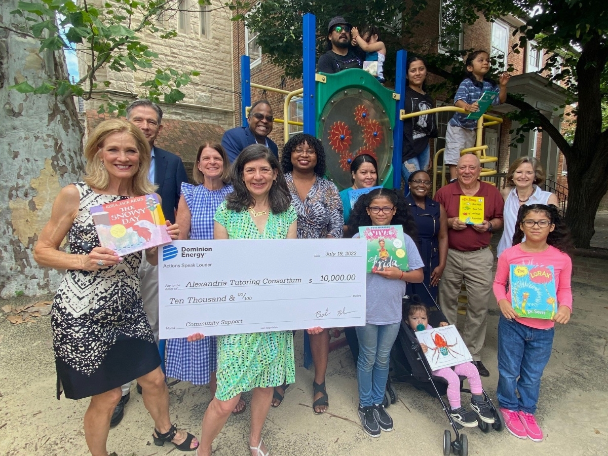 A $10,000 contribution from Dominion Energy supports Alexandria Tutoring Consortium's Book Buddies program, which helped 8-year-old Roxanna (bottom right) achieve reading proficiency above grade level. 