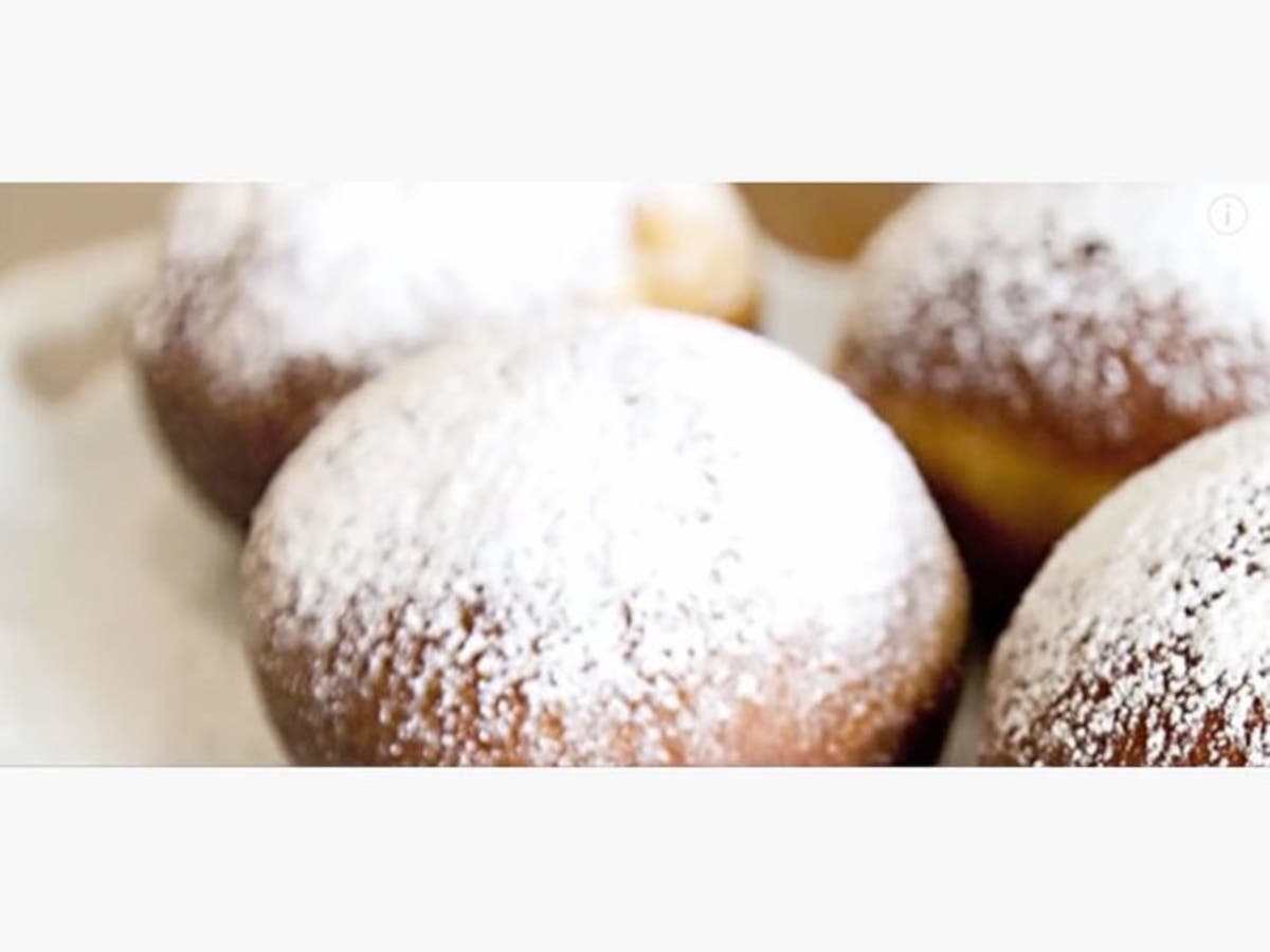 Paczki covered in powdered sugar. 