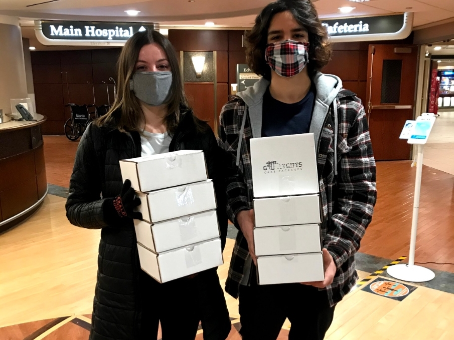Camryn Eickenberg (left) and Anthony Pendolino deliver gift boxes to essential workers at a local hospital. 