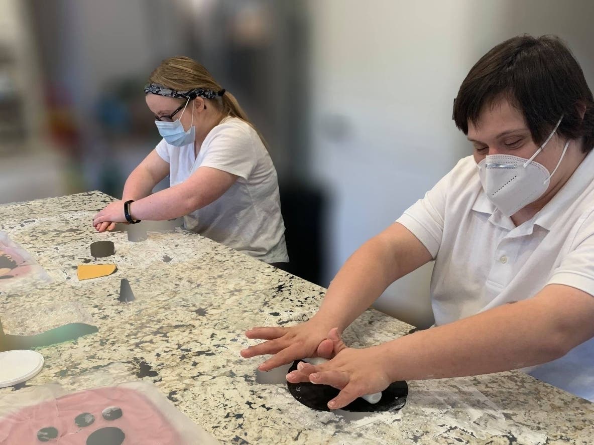Michelle Anderson and Jake Lukens prepare items to bake for customers at Moose and Me, which recently met its Kickstarter goal in the hopes of opening a new location to hire "adults of all abilities." 