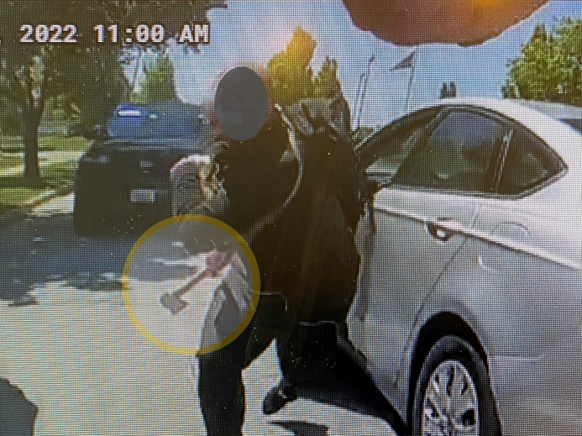 Police say the man was wielding a hatchet when he "charged" an officer who was performing an unrelated traffic stop. Above is an image from the officer's body-worn camera. 