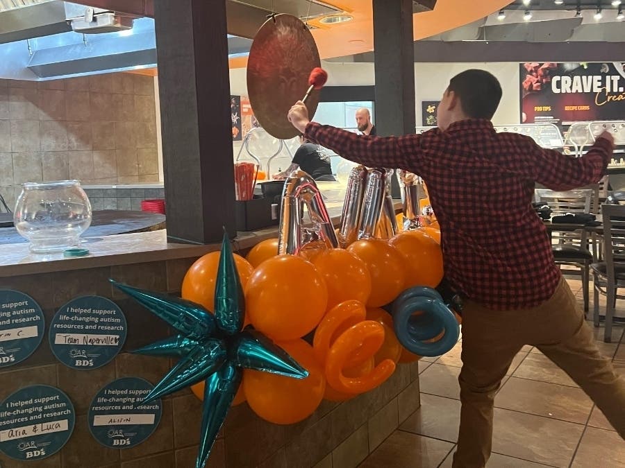 Maddox Yates-Benter, 9, who is on the autism spectrum, rang the gong at BD's Mongolian Grill to herald the start of Autism Awareness Month. 