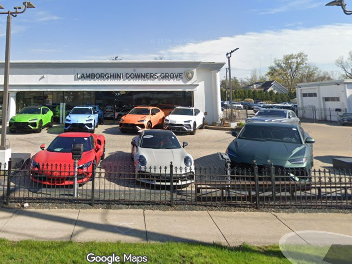 The proposal to demolish two buildings at 330 Ogden Ave. and construct a new auto dealership had its first reading Tuesday. 