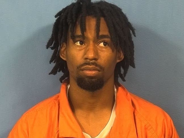 Police say Andrew Strong was armed when he knocked on the driver's car window just after they had pulled into the driveway of their home. 