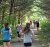 Runners pass through Whitcomb Woods during the Dedham Trails 5k Race and Sprint and Splash