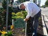 Volunteer Bob Holmes replaces the outdated sign at San Marino Landscaping Co's Sponsor A Spot at the intersection of Court and Washington Streets.