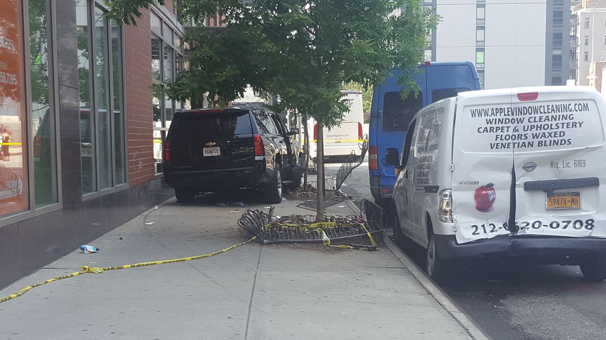 A black SUV sits on the sidewalk Thursday.