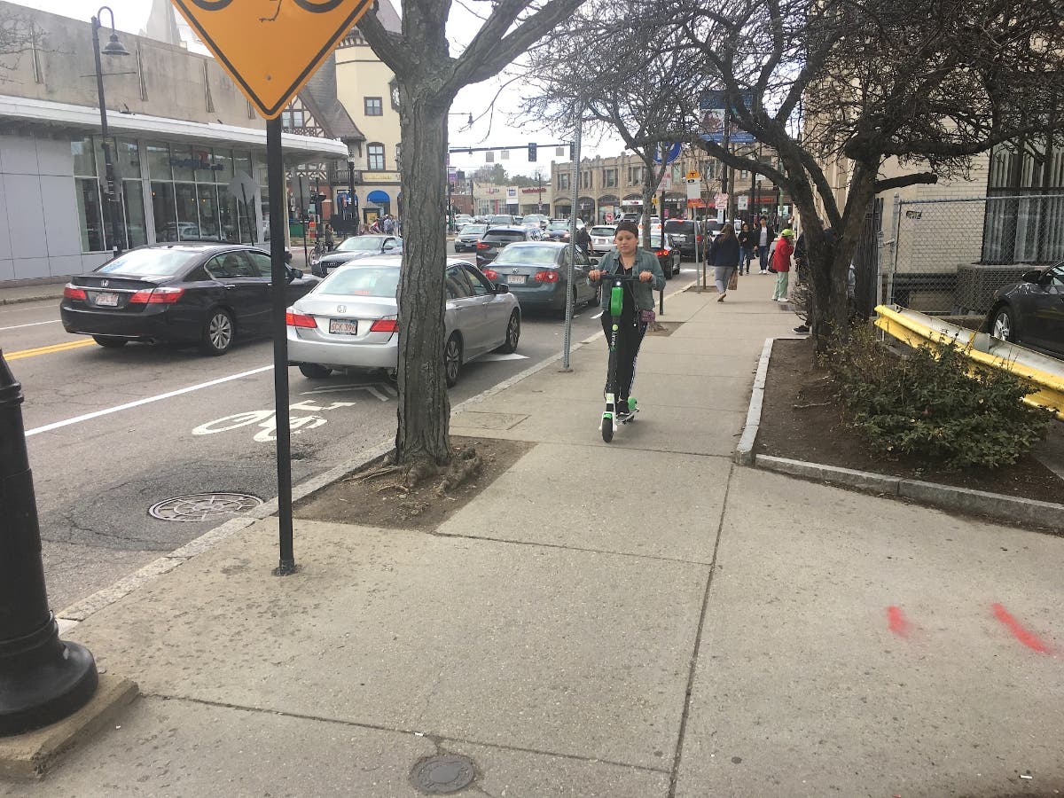 A Lime rider cruising the sidewalk near Coolidge Corner April 7, 2019.