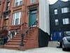 Bed-Stuy homeowner Evette Simmons is still waiting, after two years, for developers to pay to repaint her home. 