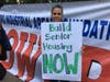 Hundreds of people rally outside Gracie Mansion Wednesday to demand Mayor Bill de Blasio fulfill a $500 million promise.