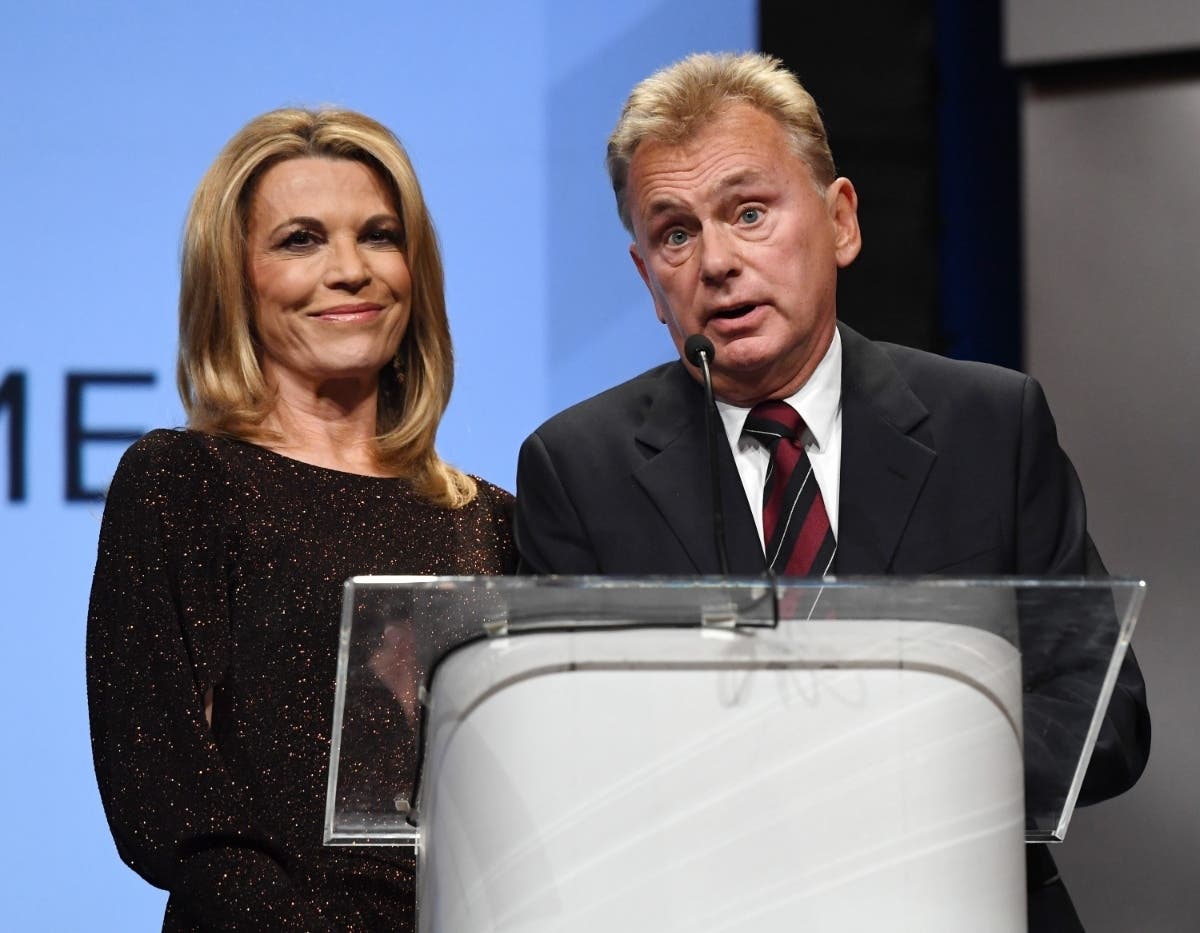 Sajak (right) is "resting comfortably and looking forward to getting back to work," producers said. Vanna White (left) is filling in as host.