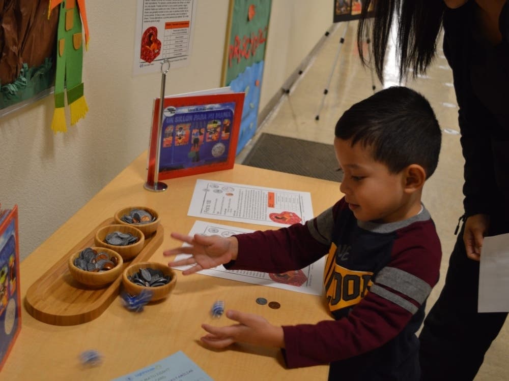 A preschooler tries out a math game at Family Math Night at the Lighthouse for Children in Fresno in this 2019 photo.