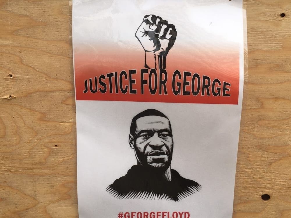 Poster of George Floyd on boarded up Chase Bank building in downtown Oakland on May 31.