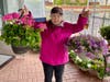 Volunteer Mary Donnelly of Bridgeport displays the Premium Geraniums and Petunias for Sale on May 13